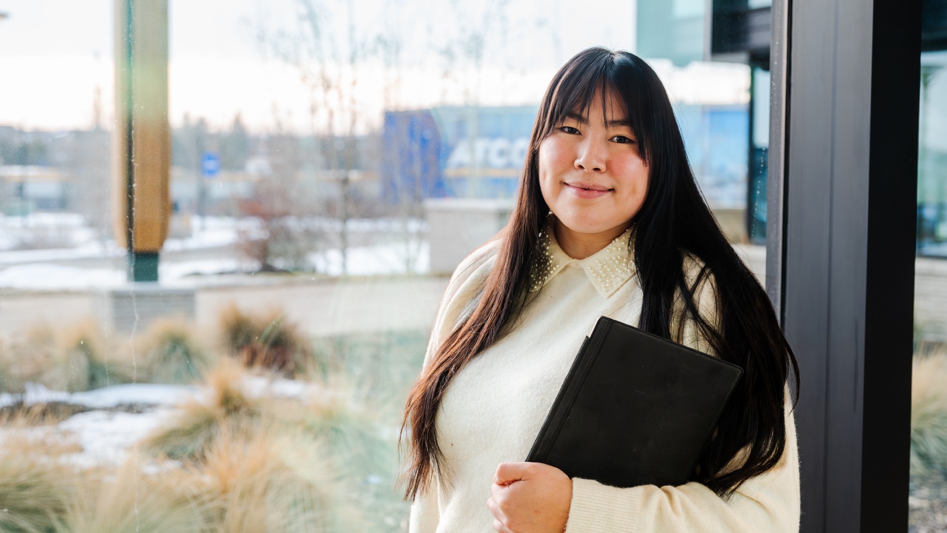 ATCO employee holding computer